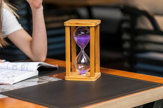 Photo of wooden hourglass on the table