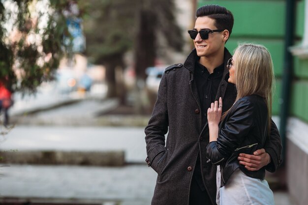 Photo of a young beautiful couple on the city street