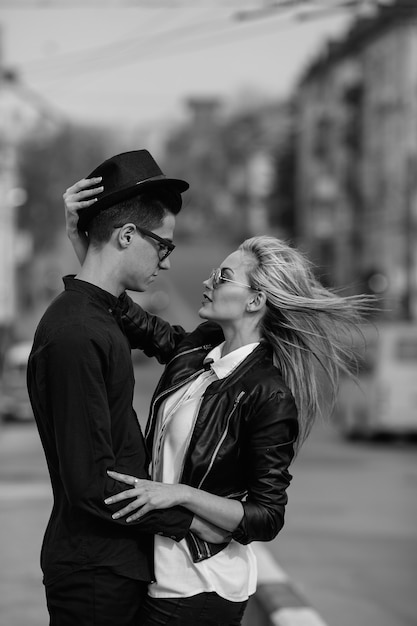 Photo of a young beautiful couple on the city street