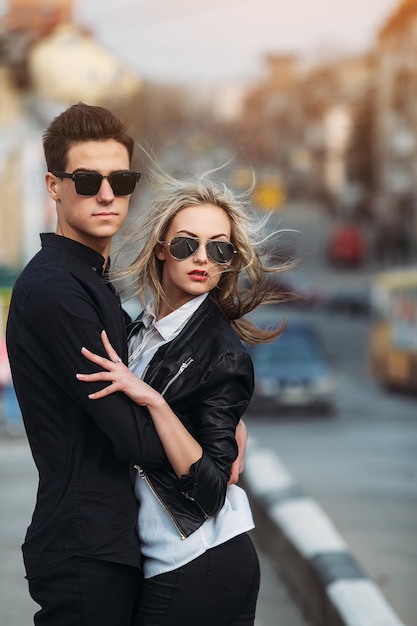 Photo of a young beautiful couple on the city street