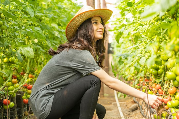 Photo of young beautiful lady at the greenhouse