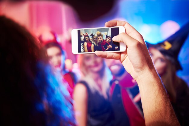 Photo of young friends having fun at Halloween party