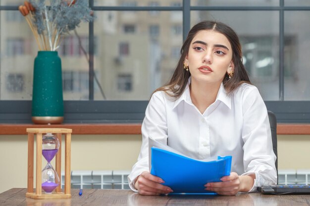 Photo of young lady holding notebook and and looking aside