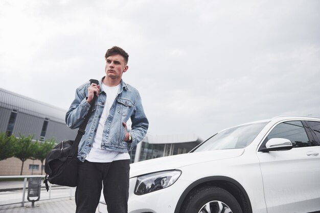 Photo of a young man before an exciting trip at the airport.