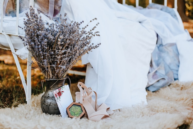 Фотозона грядки с балдахином с обувью, цветами, приглашением на природу. ткань развевается на ветру. место для фото невесты. фотосессия