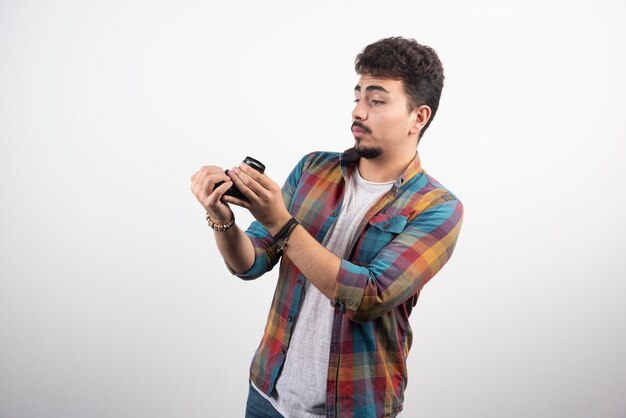 Photograph taking his selfies in a positive manner with a camera.