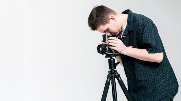 Photographer looking through camera with copy space