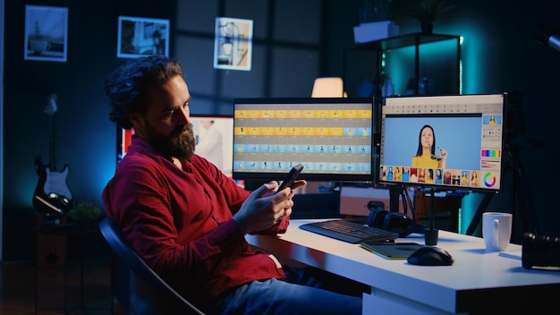 Photographer taking break from using photo editing software on PC display texting friends to relax