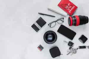 Free photo photographic equipment, spiral notebook and personal accessories on background