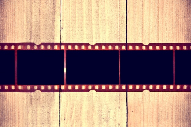 Photographic film on wooden background.