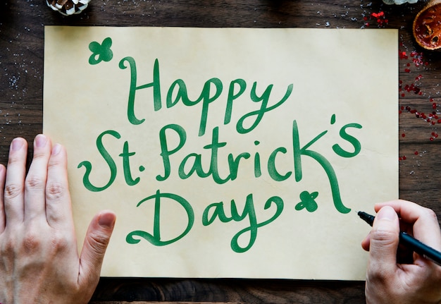 Free photo phrase happy saint patrick's day on a yellow paper