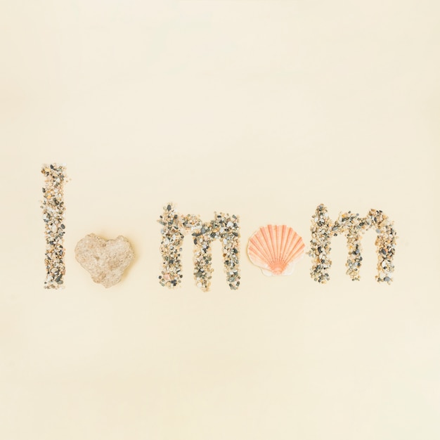 Phrase I love you mom made of sand and shell
