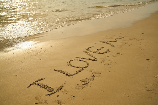 Phrase "i love you" written in the sand