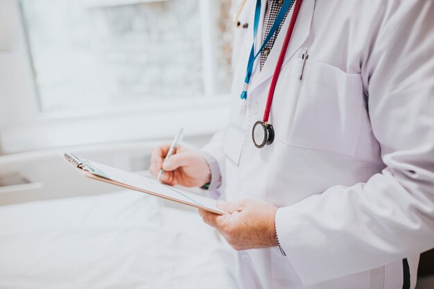 Physician noting down symptoms of a patient