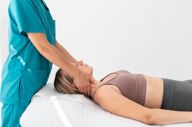 Physiotherapist giving a massage to her patient at the clinic