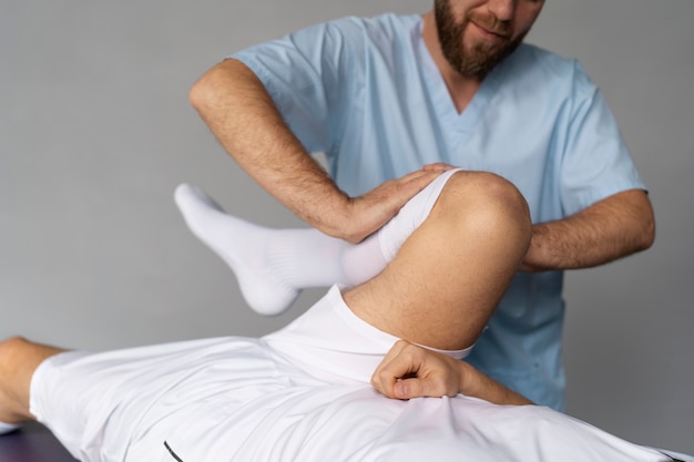 Physiotherapist helping patient front view