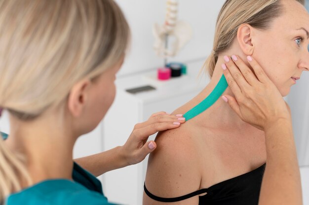 Physiotherapist helping a patient at her clinic