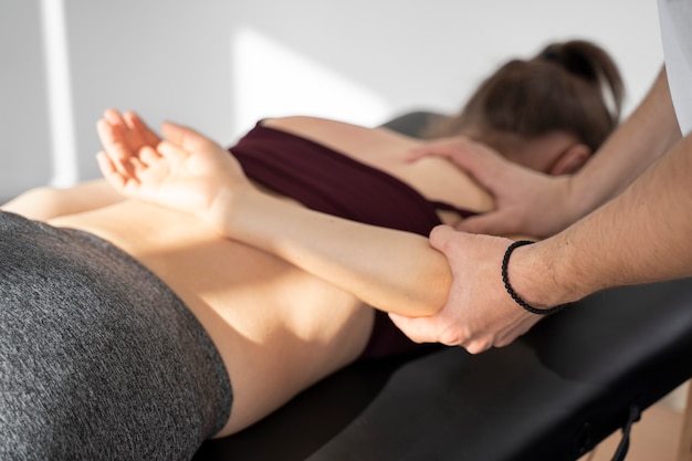 Physiotherapist helping patient recover close up