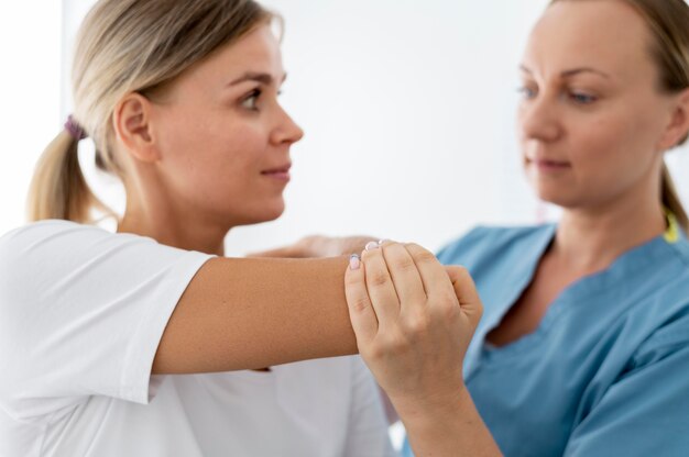 Physiotherapist helping a young female patient at her clinic