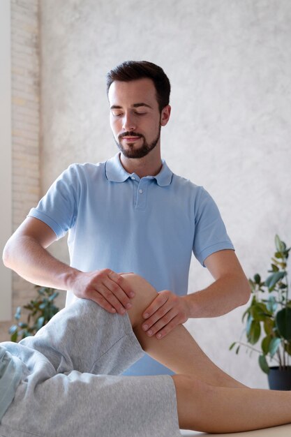 physiotherapist massaging patient close up
