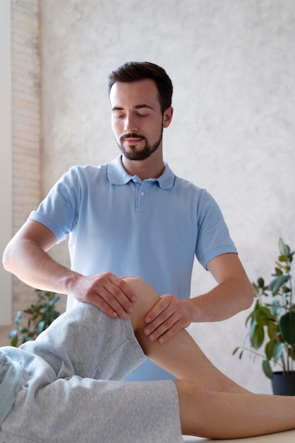 Physiotherapist massaging patient close up