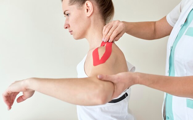 Physiotherapist undergoing therapy with female patient