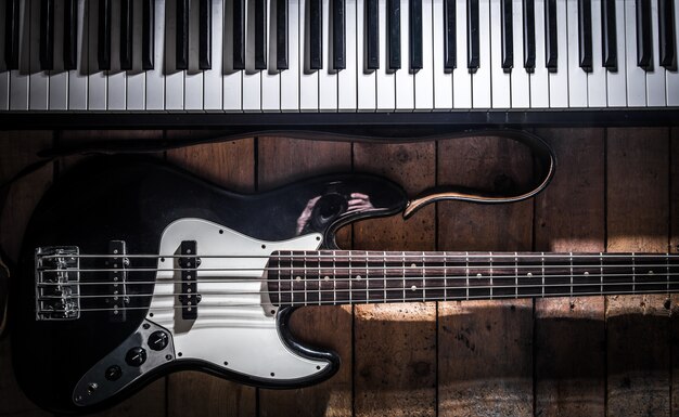 piano and guitar on wooden background closeup