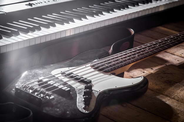 piano and guitar on wooden background closeup