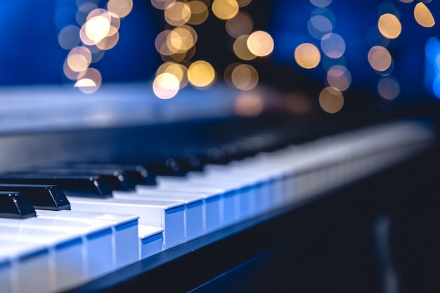 Free photo piano keys closeup on a blurred background with bokeh