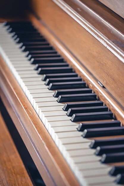 Piano keys on wooden brown musical instrument