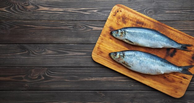 Pickled atlantic herring fishes on a cutting board