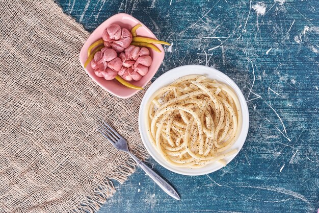 Pickled garlic and plate of spaghettion marble. 