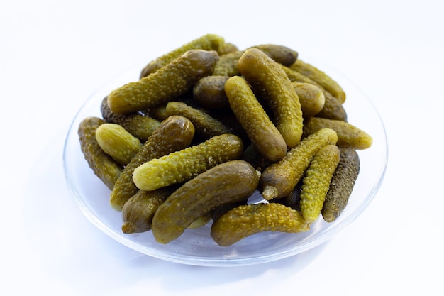 Pickled gherkins or cucumbers on white background.