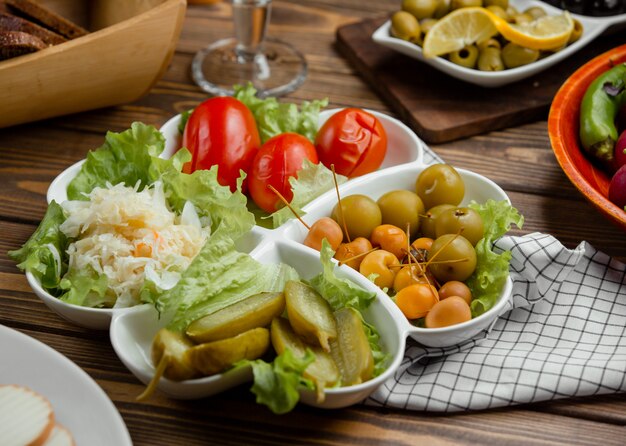 Pickled plate of cucumber, tomato, cabbage, greengage, mini apples