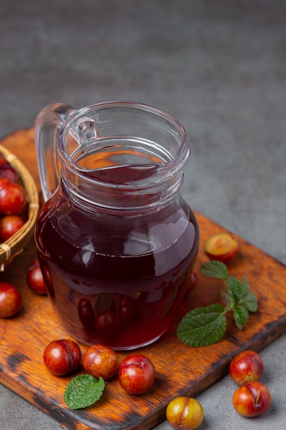 Pickled Plums on the dark surface.