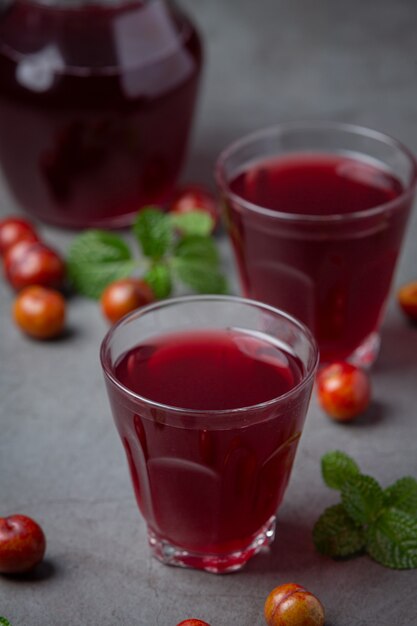 Pickled Plums on the dark surface.