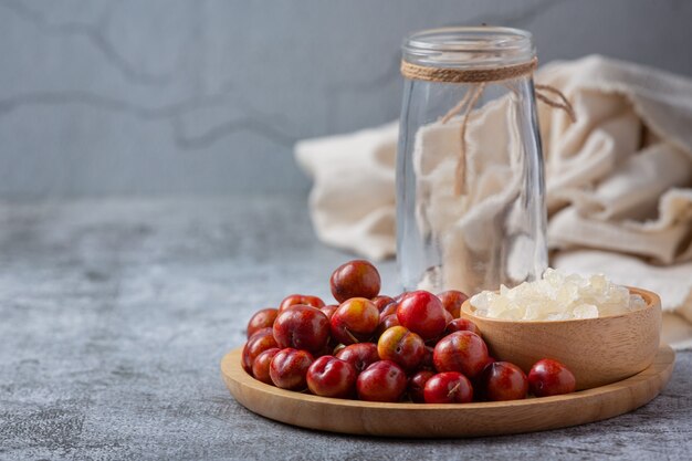 Pickled Plums on the dark surface.