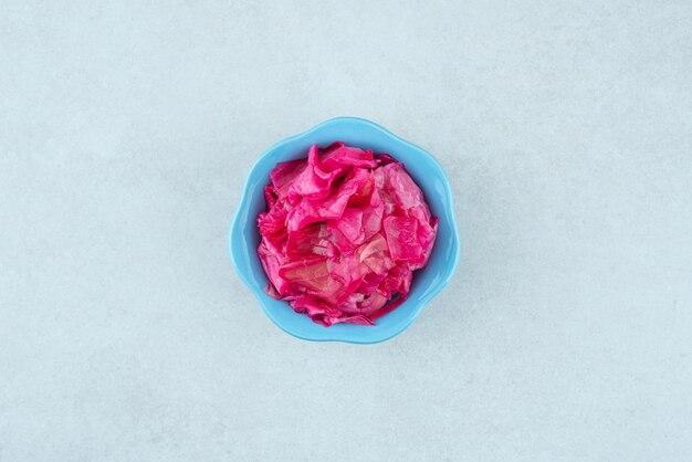 Pickled red cabbage in blue bowl.