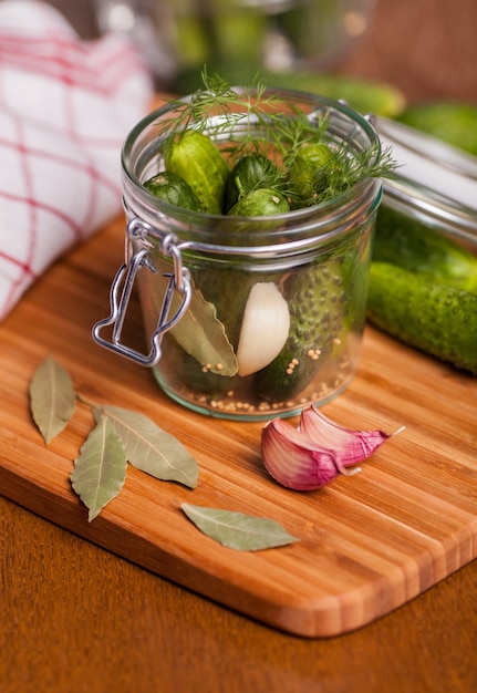 Pickles with garlic and drill in glass jar 
