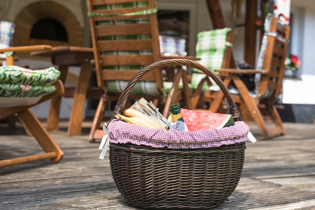 Picnic basket filled with fruits and bottle