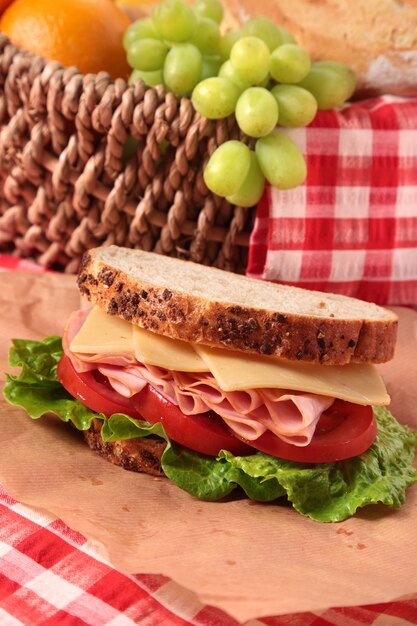 Picnic basket and ham and cheese sandwich