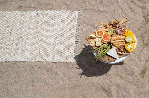 Picnic on a sandy sea beach top view. Vacation and vacation concept.