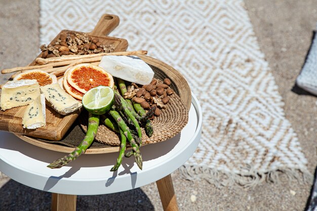 Picnic with delicious beautiful food on the table close up. Outdoor recreation concept.