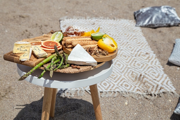 Picnic with delicious beautiful food on the table close up. Outdoor recreation concept.