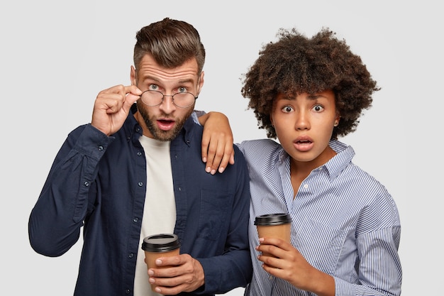 Picture of astonished mixed race woman and man stare with surprised expressions