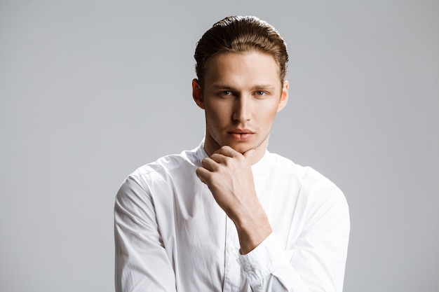 Picture of attractive caucasian man over white wall