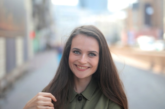 Picture of a beautiful smiling woman with mesmerizing green eyes against a blurry background