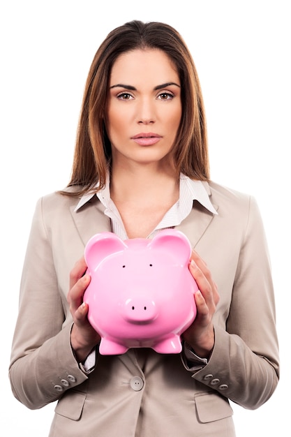 Picture of beautiful woman with piggy bank on white background