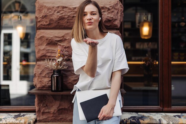 Picture of caucasian attractive woman send fly kiss to camera