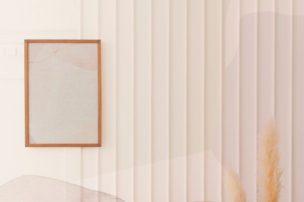 Picture frame hanging on a white wall by the dried pampas grass